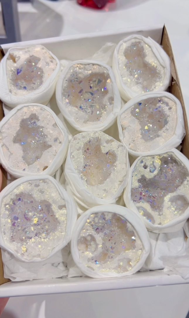 Box of white quartz geodes with glittery interior in a box