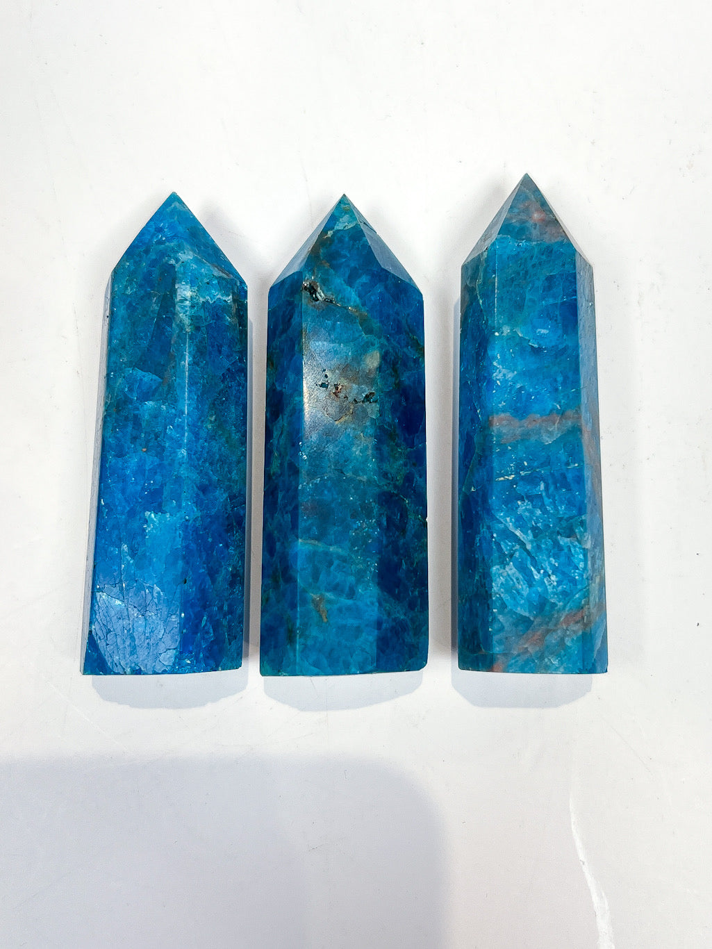 Three blue crystal points on a white background
