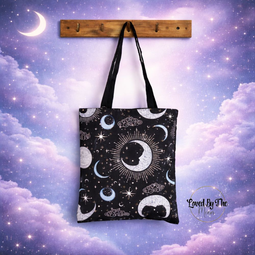 Blue Celestial Print Tote Bag in front of purple and pink celestial sky background.