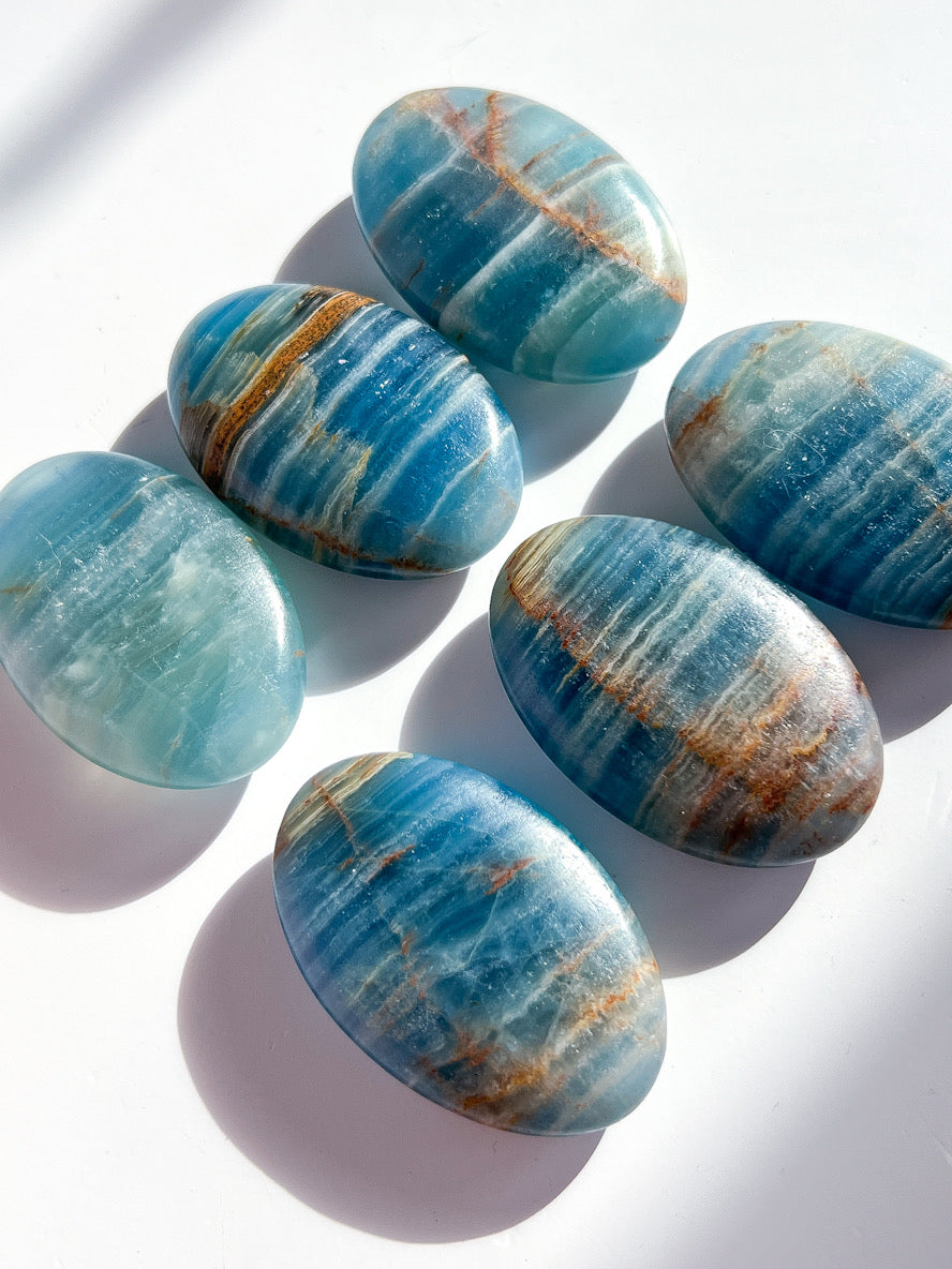 Blue and brown striped stones on a white background