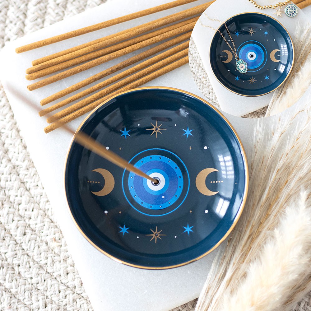 Celestial Protective Eye Incense Stick Holder in birds eye view with incense sticks in the background.