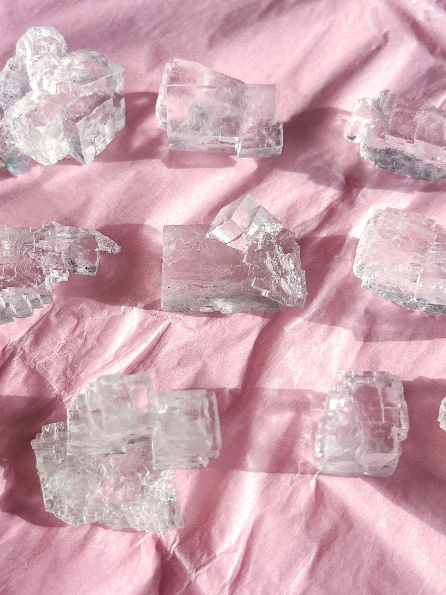 Clear Halite Crystal Specimens from Poland on pink tissue paper