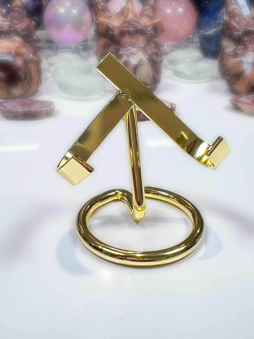 Gold metal stand with a cross design on a white background