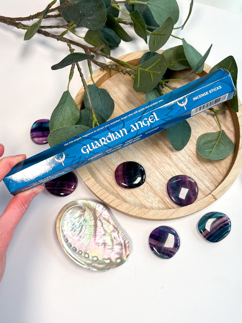 Guardian Angel incense sticks packaging with amethyst stones and a shell on a white background