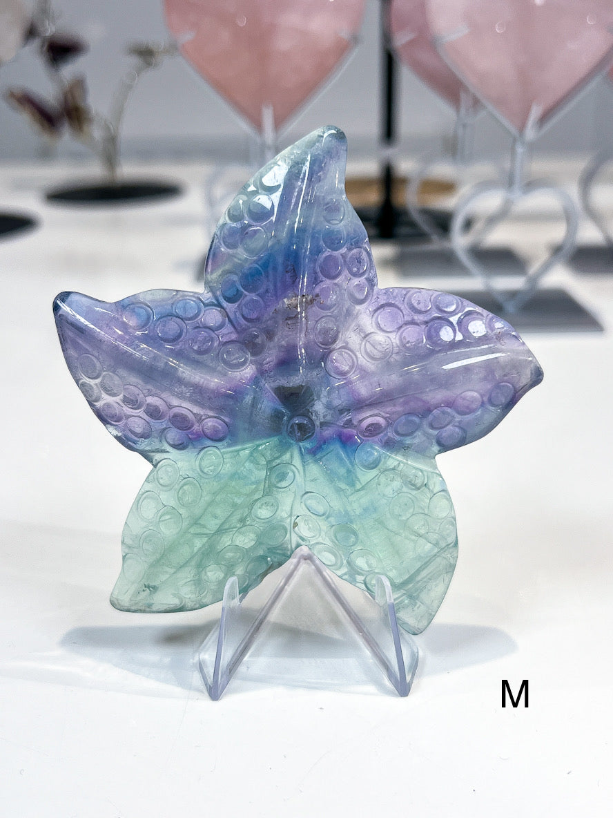 Starfish crystal carving with a bubbled texture and colours of green, purple and blue.