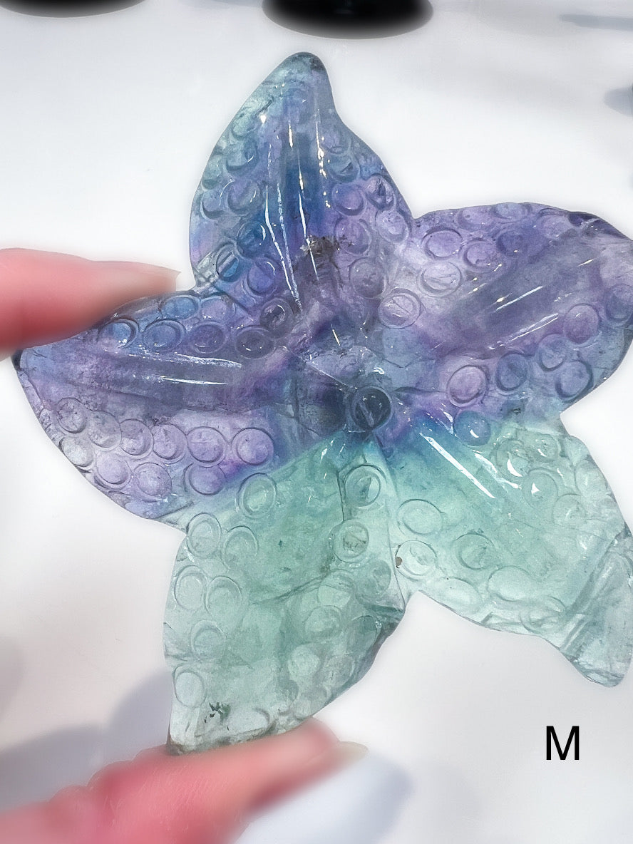 Starfish crystal carving with a bubbled texture and colours of green, purple and blue.