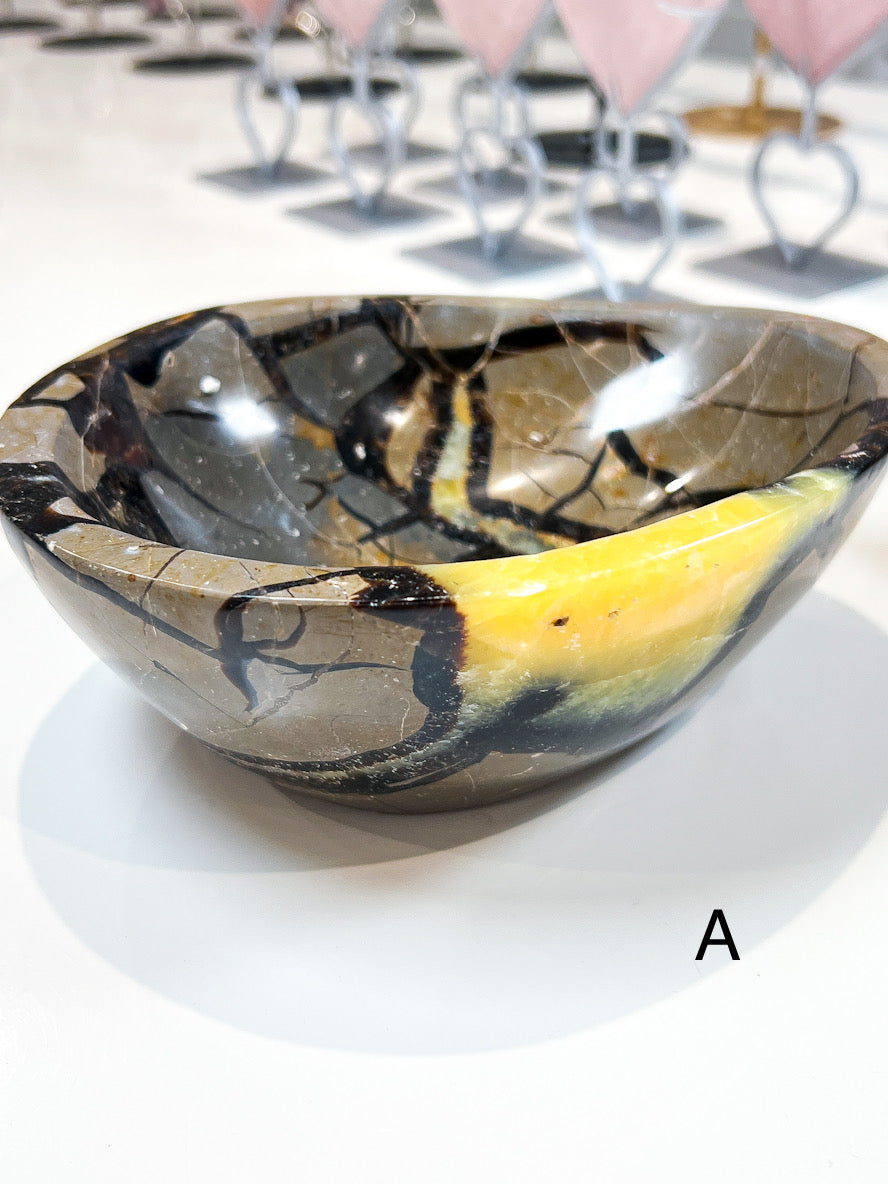 Decorative bowl with a marbled design on a white surface