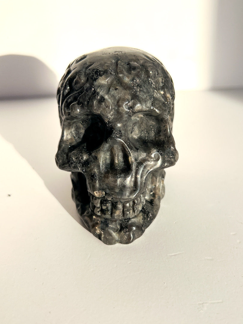 Black stone skull on a white surface