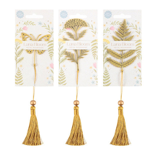 Three gold tassel bookmarks with leaf designs on packaging, branded 'Lana Bloom'.