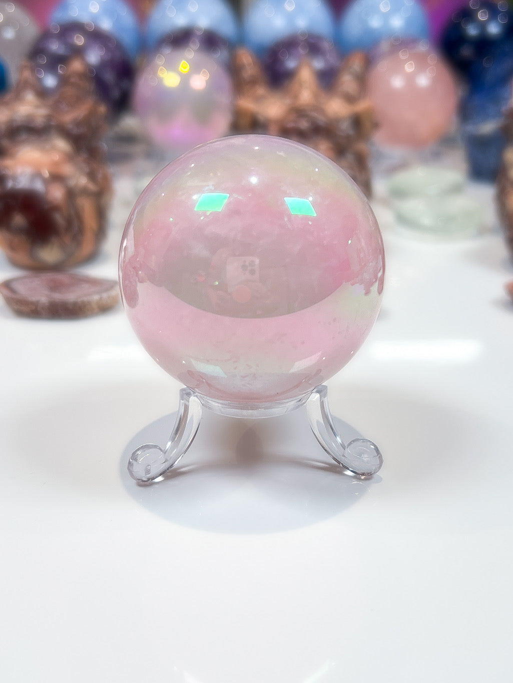 Multicolored crystal ball on a stand with blurred background
