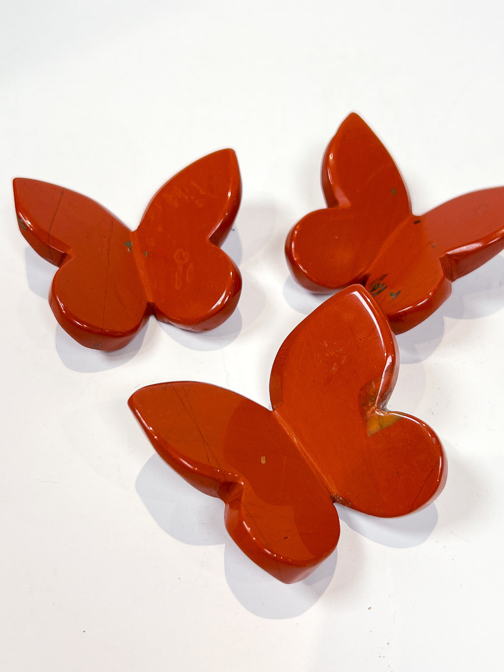 Red Jasper butterfly carving on white background