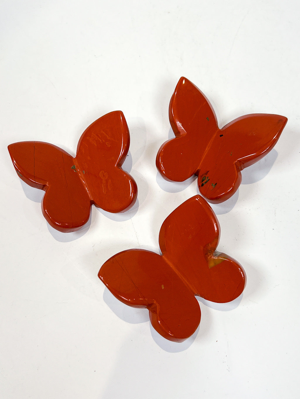 Red Jasper butterfly carving on white background