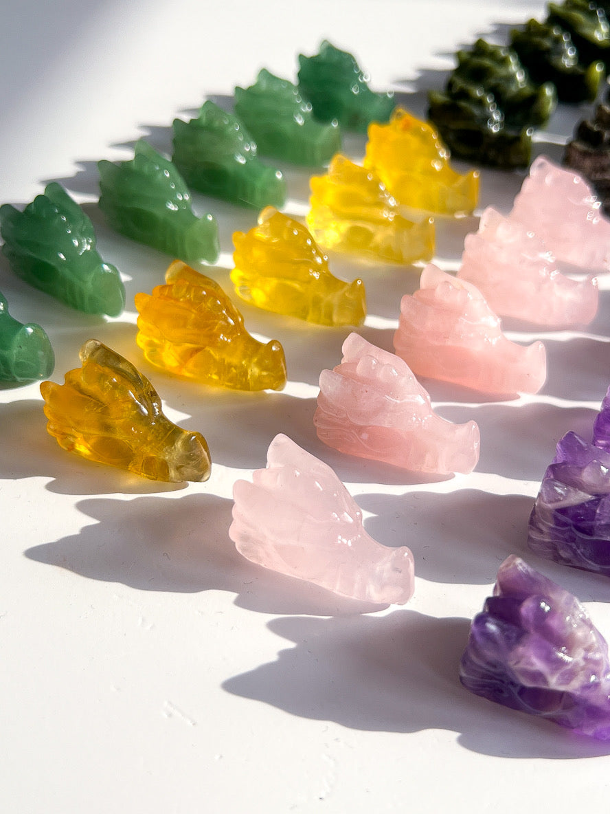 Colorful crystal-like objects arranged in a row on a white surface