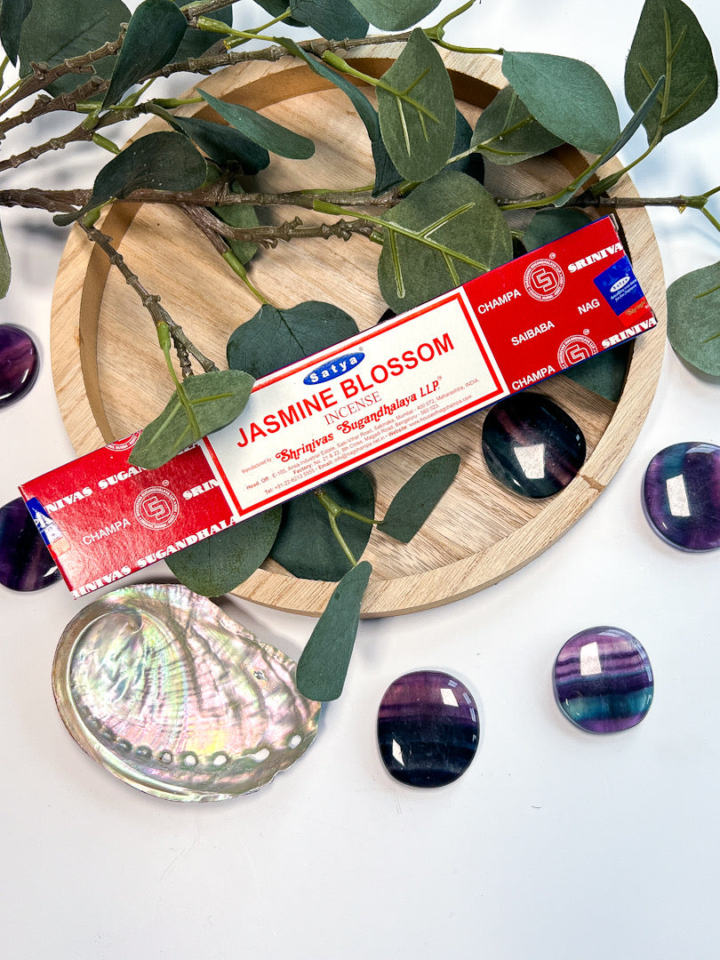 Jasmine blossom incense stick box on a decorative setting with leaves and stones