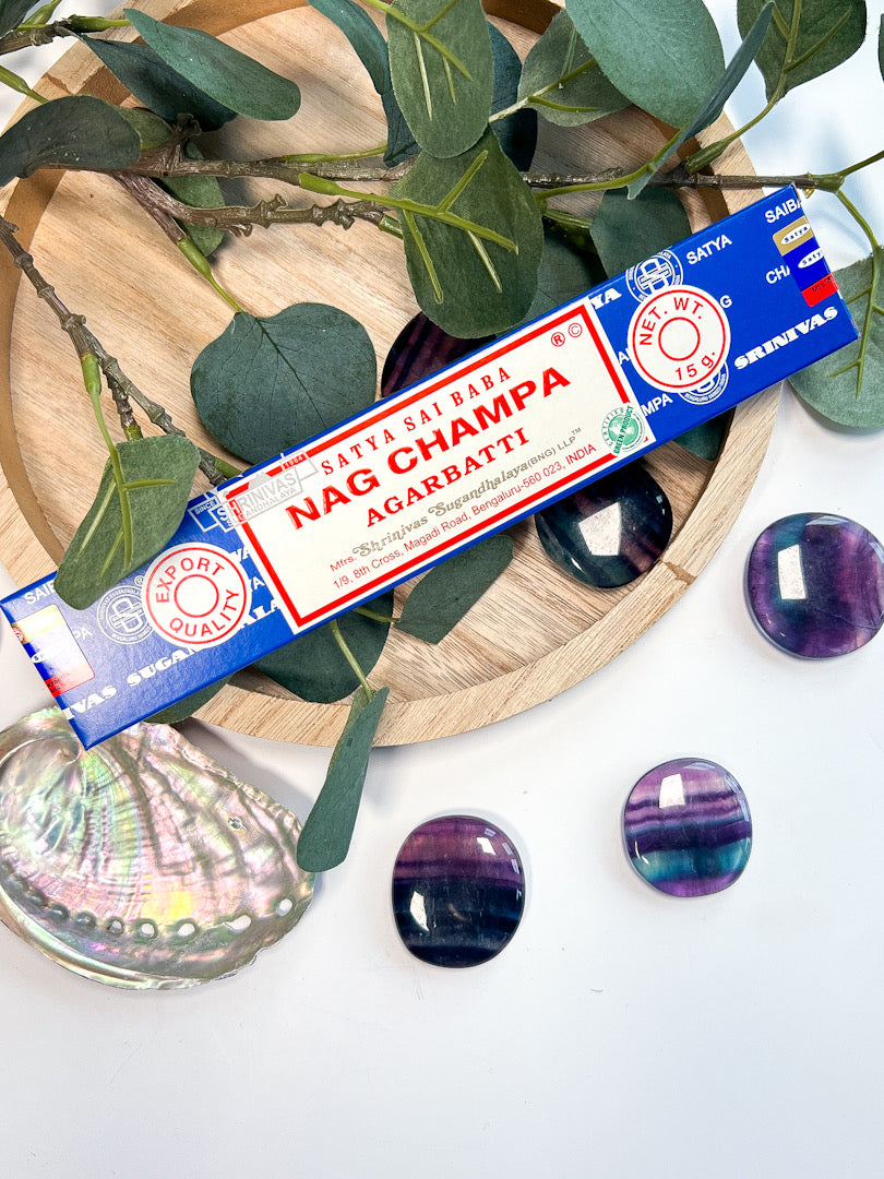 Satya Nag Champa incense on wooden tray surrounded by crystals