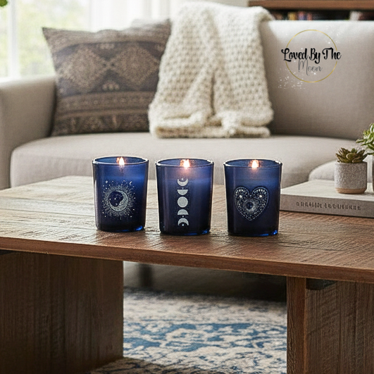 Set of 3 Blue Celestial Candle Holders on a wooden table with a cream sofa in the background.