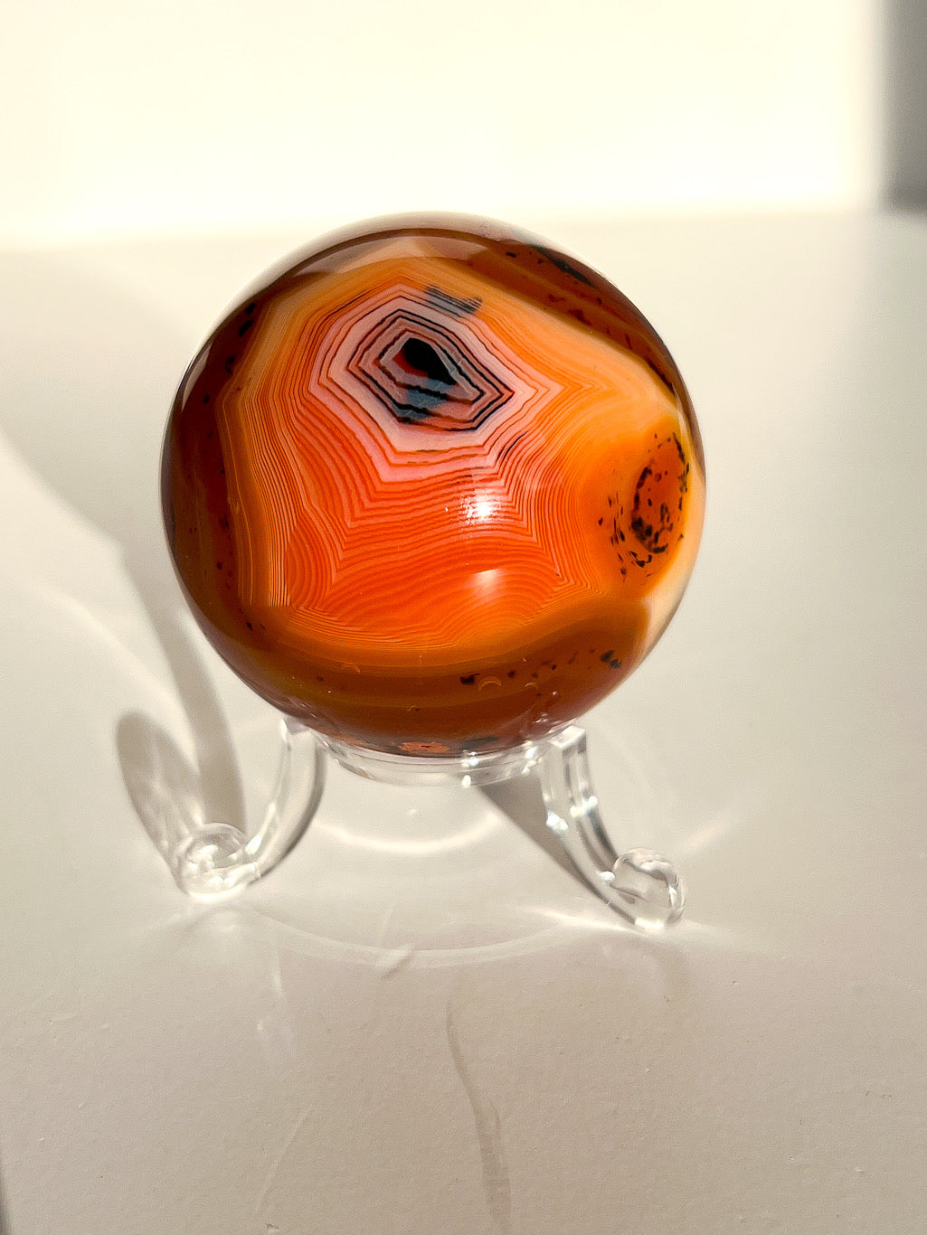 Agate stone on a clear stand with a white background