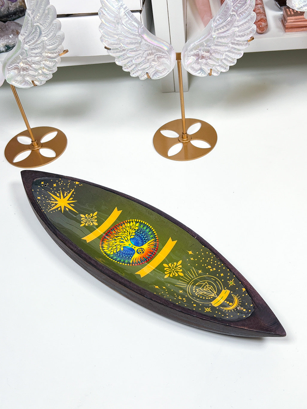 Decorative wall art with colorful design and angel wings on a white background