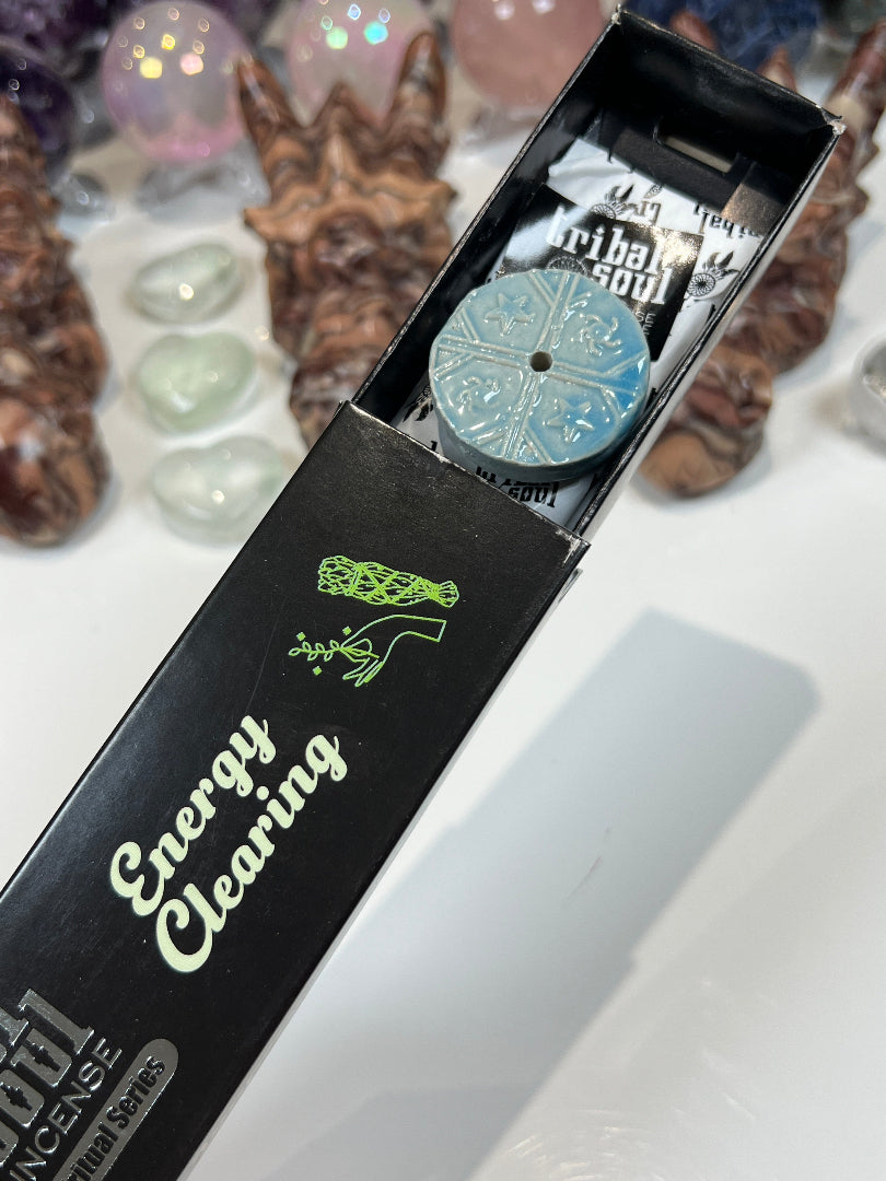Close-up of a black box with green text and designs, featuring a white background.