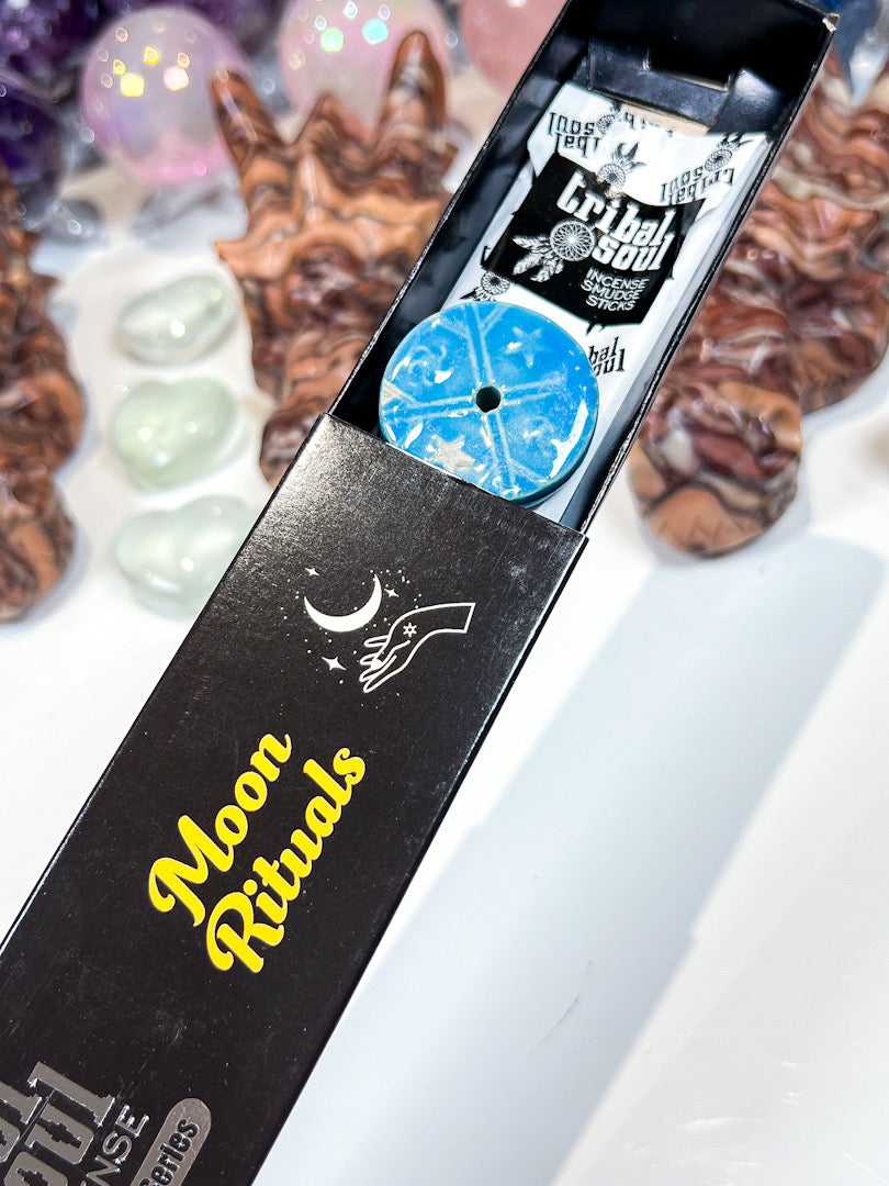 Product packaging with 'Moon Rituals' text and mystical design elements on a white background.