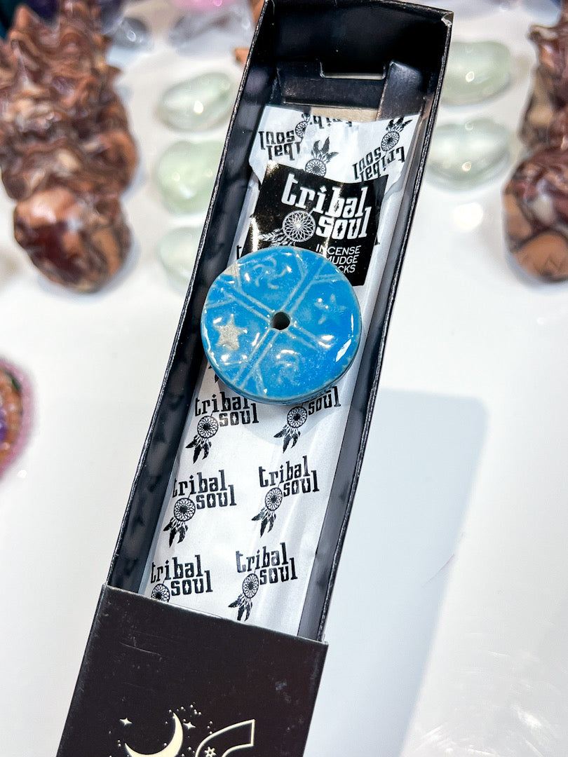 Blue circular object with 'Tribe Soul' branding in a black packaging box.