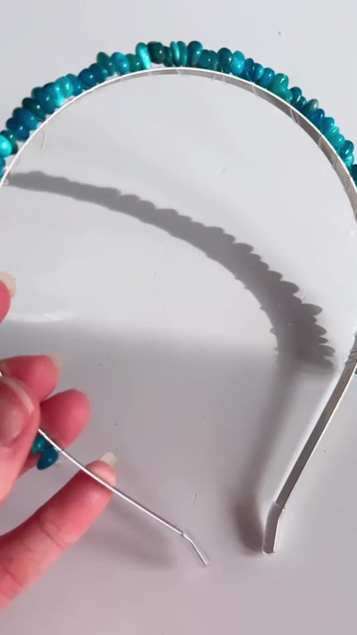 Amethyst and Apatite crystal chip headband in hand with white background.