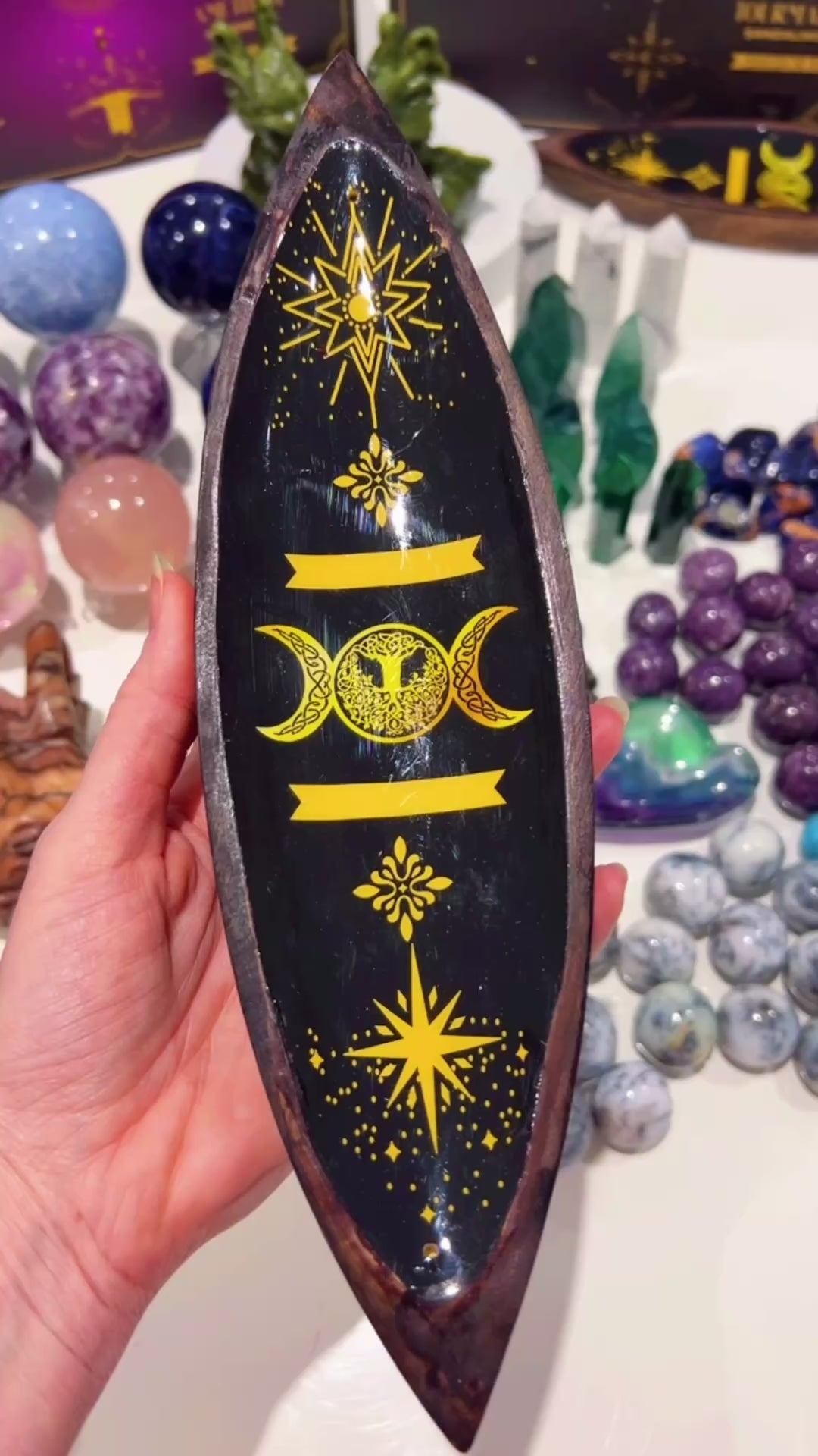 Triple Moon Incense Stick holder in hand with crystals in the background