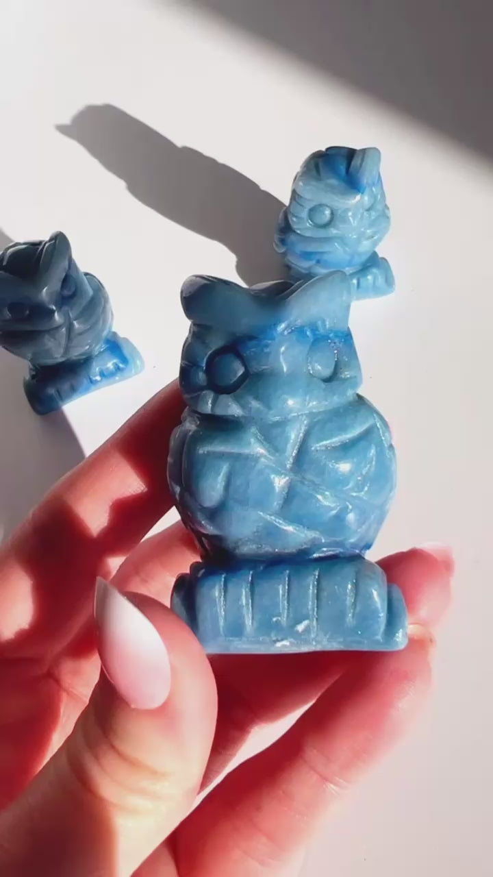 Blue Aventurine Owl Carving  in hand with white background