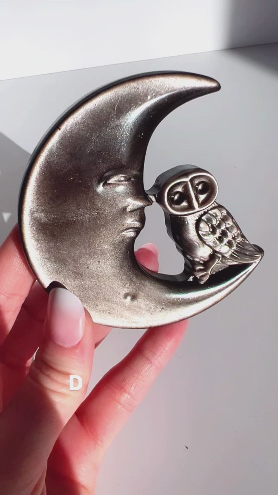 Silver Sheen Obsidian Moon & Owl Carving D in hand with white background.