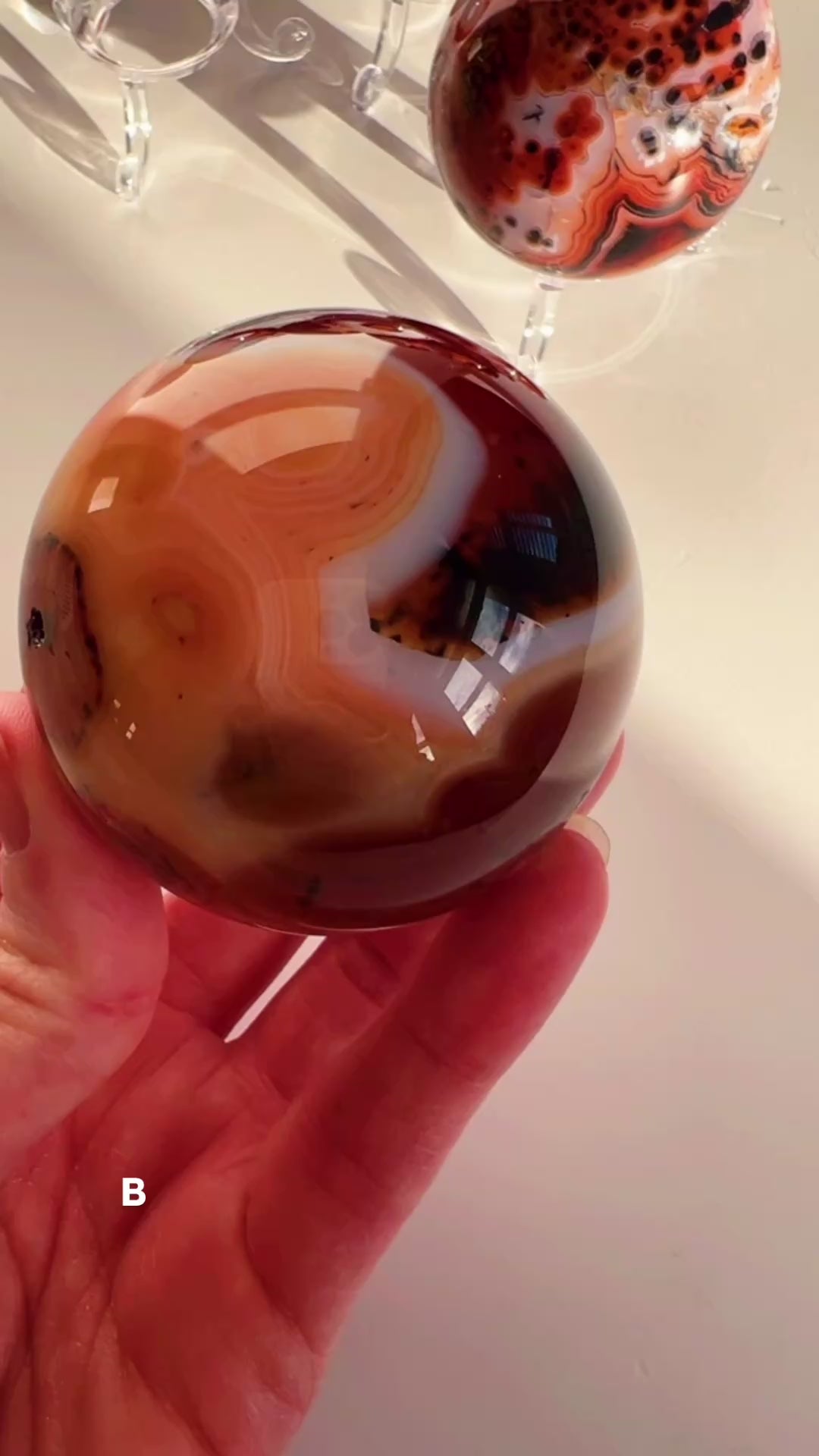 Silky Agate sphere with white background.