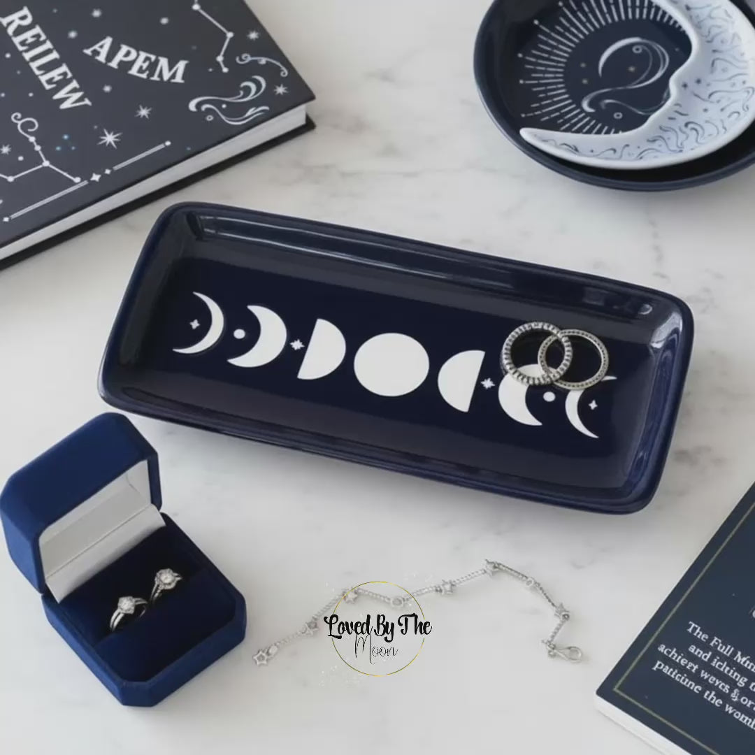 Blue Moon Phase Trinket Dish on a white marbled table surrounded by blue homeware