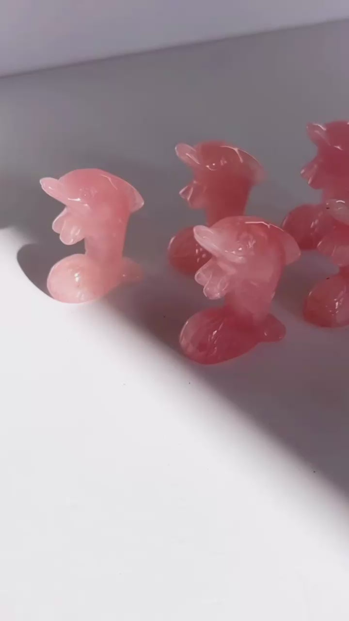 Rose Quartz Dolphin Carvings on a white background
